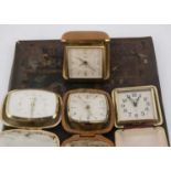 Four first quarter and half 20th century travel clocks