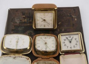 Four first quarter and half 20th century travel clocks