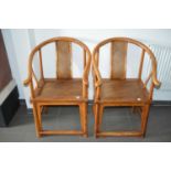 A pair of late 19th century Chinese elm horseshoe back chairs,