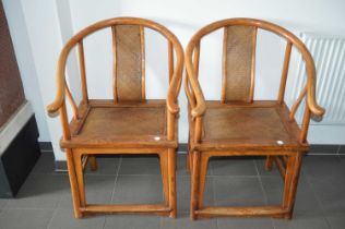 A pair of late 19th century Chinese elm horseshoe back chairs,