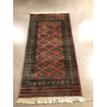 A signed Persian woollen rug,