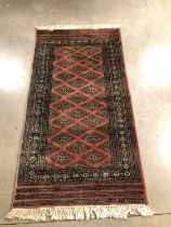 A signed Persian woollen rug,