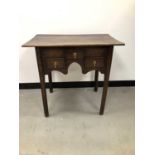 A small 18th century and later oak lowboy,