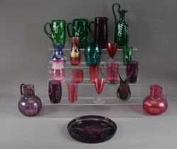 An assorted collection of coloured glassware,