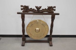 A modern Chinese carved wooden and brass dinner gong,