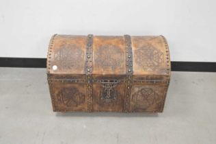 A vintage African wooden and metal bound domed lidded trunk,