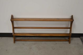 A c. 1970's recoil elm rack, with two tiers, a sticker to the top, 48cm H x 96cm W