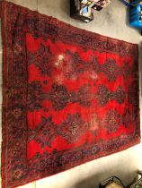 A large and damaged colourful oushak woollen rug,