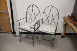 A pair of modern painted metal conservatory chairs,