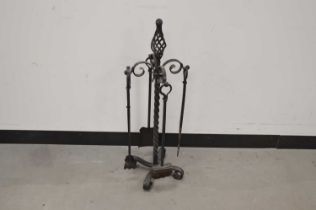 A modern black painted cast iron fire side set