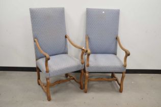 A pair of carved wooden and upholstered armchairs