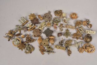 A collection of WWI and later Regimental cap badges,