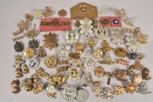 A good selection of British cap badges and titles,