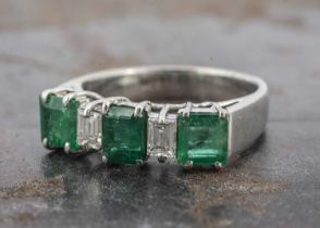 A white gold emerald and white stone dress ring,