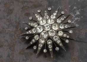 An early 20th Century silver and paste set twelve point star brooch,