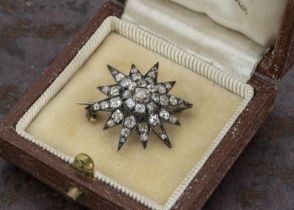 An Edwardian old cut diamond twelve point star cluster brooch,