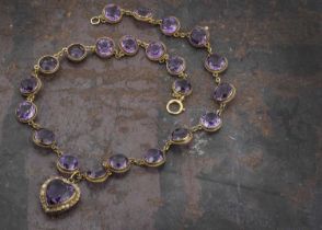 An Edwardian amethyst and seed pearl heart shaped pendant and chain,
