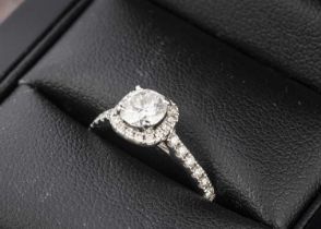 An AGI certified diamond halo solitaire dress ring,