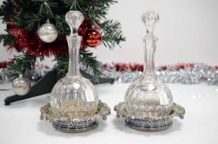 A pair of Victorian silver plated wine bottle coasters by Elkington & Co with East Devonshire silver