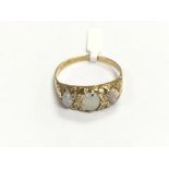 An 18ct gold three stone opal ring set with four s