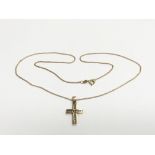 A 9ct gold cross pendant set with diamonds and sus