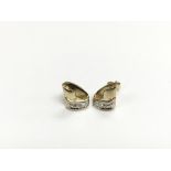 A pair of 9ct gold diamond set ear studs, approx 1