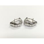 A pair of 14ct white gold diamond set earrings, ap