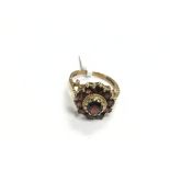 A 9ct gold ring set with garnets, approx 4g and ap