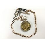 A yellow metal fob watch on a gold chain.