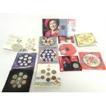 A collection of uncirculated UK coin sets and roya