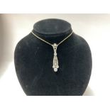 A 1920s 18ct and platinum pendant inset with appro
