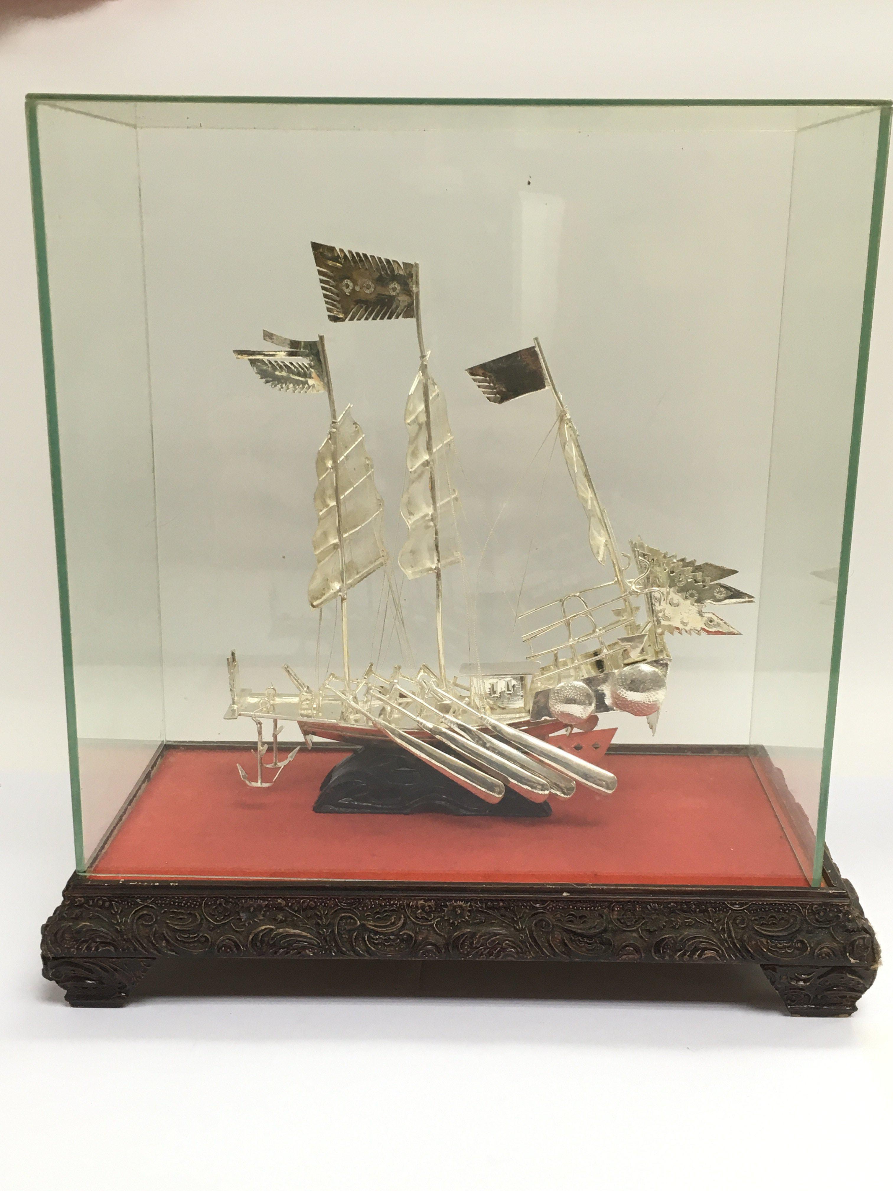 A white metal model of a Chinese junk in a present