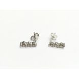 A pair of 9k white gold triple diamond stud earrin