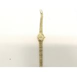 A 9ct gold ladies watch. Strap is also 9ct. Total