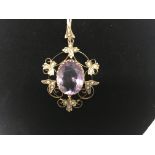 A Edwardian 9 ct pendant of floral design with cen