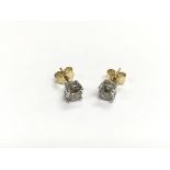 A pair of white gold studs set with diamonds and w