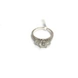 An 18ct white gold three stone diamond ring, centr