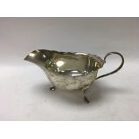 Hallmarked silver gravy boat with a shell butter d