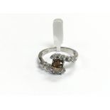 A 9ct white gold crossover ring set with a faceted