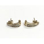 A pair of 9ct gold diamond set stud earrings, appr