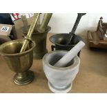 A collection of four mortar and pestles .