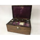 A Quality rosewood traveling case with fitted bott