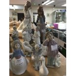 A collection of Lladro , Nao and similar style figures.