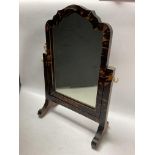 A small tortoiseshell veneer dressing table mirror