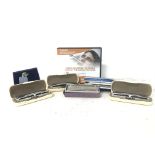 A collection of vintage cased harmonicas including