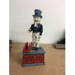 A cast iron U S money box repainted.