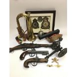 A collection of military related items comprising a bugle, RAF badges, model cannon etc.