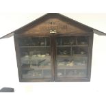 A collectors cabinet containing Wade whimsies (a l