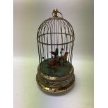 Vintage singing birds in wire cage,