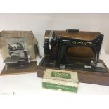A Singer sewing machine in an oak case as new a sm